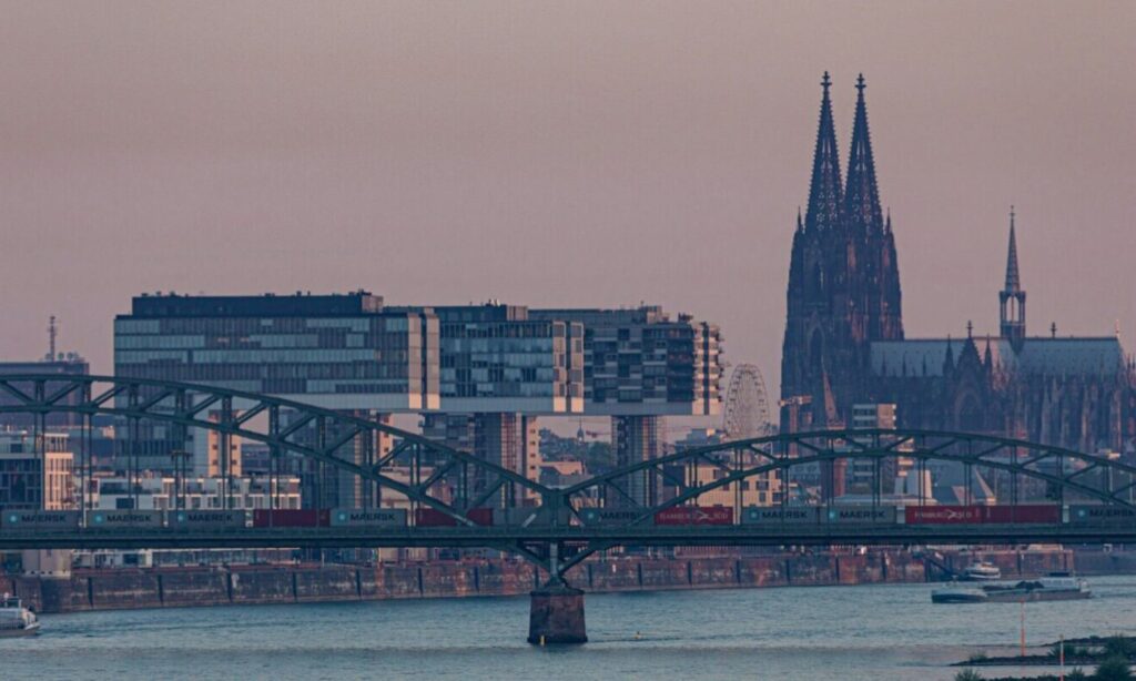 black and white boat on body of water near bridge during daytime